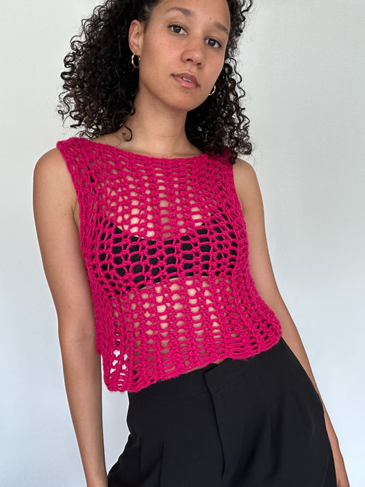 Shows the bright pink crocheted ROCO Tank Top which has an open mesh design. Made by The Woollers