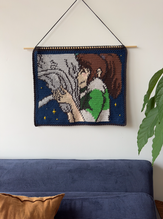 Shows our crocheted tapestry of a still out of the movie 'Spirited Away', in which Haku and Chihiro are embracing. Made by The Woollers 